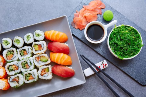 Sushi Maki and Niguiri California roll with seaweed chuka salad soy sauce and wasabi