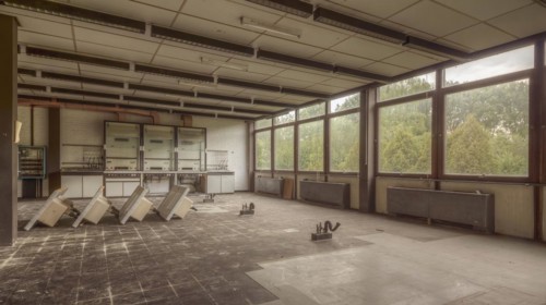 A dilapidated room with broken furniture and windows through which daylight shines, Institute of