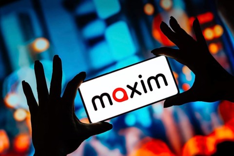 In this photo illustration, the Maxim logo is displayed on a smartphone screen
