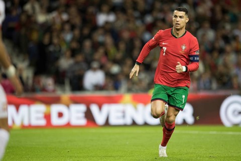 Football match, captain Cristiano RONALDO CR7 Portugal running slowly to the left with a