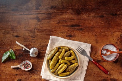 Pickled cucumbers with salt, pepper, garlic, and bay leaf. Fermented food. Homemade canned gherkins