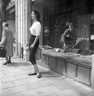 Young woman in 1956. She is standing in front of a shop window on Strandvägen in Stockholm and