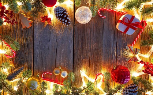 Christmas glowing stars and fir on vintage wooden background copy space