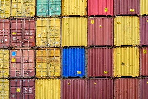 Standard shipping container in a container terminal in front of loading onto a container ship