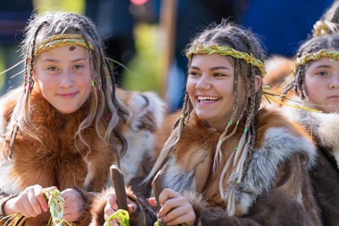 Two expression smiling girls in traditional clothing aboriginal of Kamchatka Peninsula. Itelmens