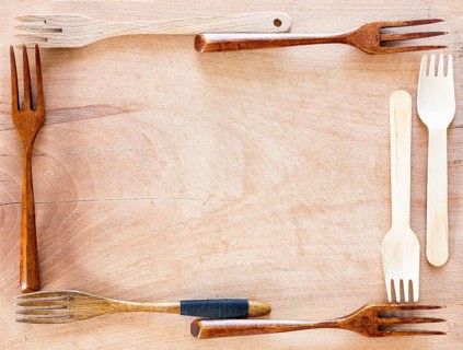 Wooden kitchenware frame on a wooden background from above. Studio shot. Kitchen utensil