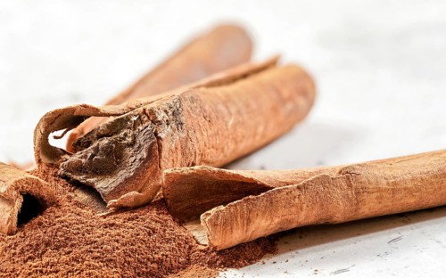 Closeup detail - Heap of cinnamon bark sticks on white stone like desk, Liptovsky Hradok, Slovakia,