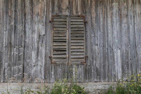 Wooden wall with closed wooden shutters from the former Brunner staff house which has since been