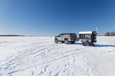 Winter, car with a heated trailer on the frozen Saint Lawrence River, Province of Quebec, Canada,