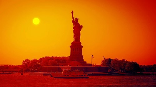 An image of the Liberty Statue at sunset