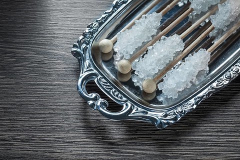 Tasty sugar sticks on metallic tray