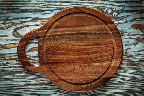 Carving board on wooden surface
