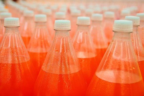 Orange juice beverage plastic bottle in factory line