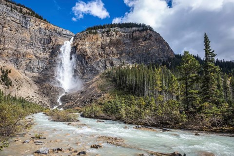 Rocky Mountains of Canada. Autumn Takakkaw Falls forms a full-flowing water flow of pearl color.