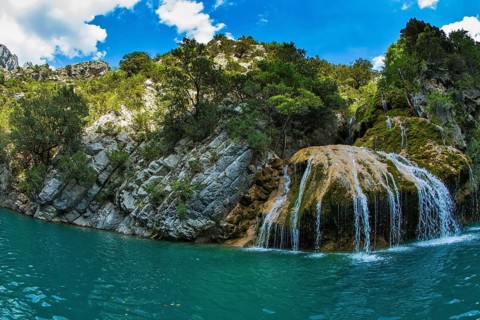 Scenic round waterfall in the side wall of the canyon Verdon. National park Merkantur, Provence,