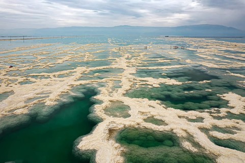 Drone photography. Salt evaporated from the water forms bizarre patterns in the shallow sea water.