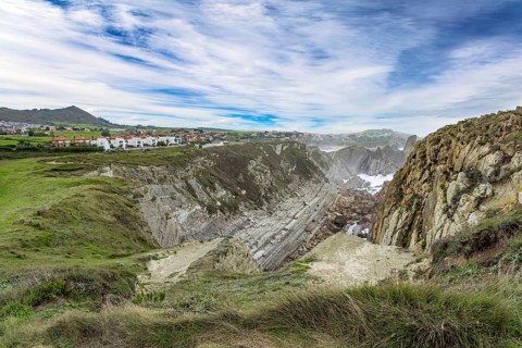 Cantabria Beaches, Portio Beach. Windy stormy day on the Atlantic coast. Giant rough gray rocks and