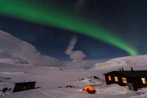 Northern Lights (Aurora borealis) over moonlit mountains on the long-distance hiking trail