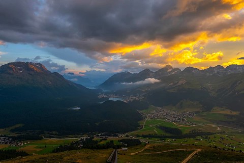 Beautiful Aerial View over Five Lakes and Swiss Alps and Cityscape in Sunset and Storm Clouds over