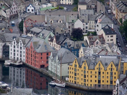 Colourful buildings on the harbour are reflected in the water. Historic architecture and