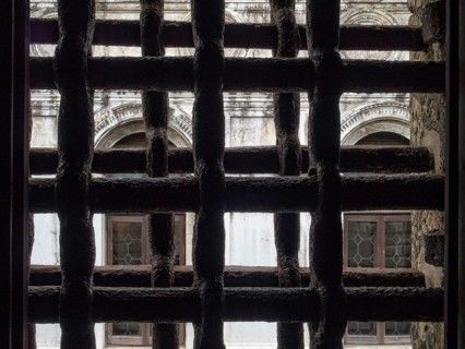 View trough iron grills of Circolo Artistico, the former prisons' building of the Doge's Palace,