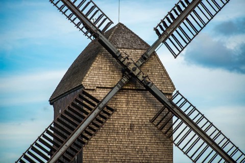 Large brown windmill in front of a blue sky in Berlin, Marzahn