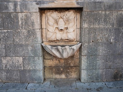 Stone relief, frog, fountain in the old town centre of Korcula, island of Korcula, Dalmatia,