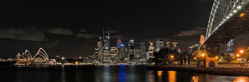 Sydney Opera House at night from Milsons Point and with skyline in the background. Reupload after