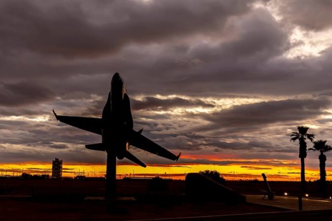 Dawn at Naval Air Field El Centro, CA: Sunlight paints vibrant hues across the sky, casting a