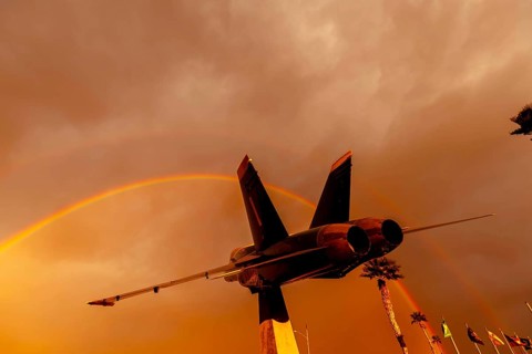 Dawn at Naval Air Field El Centro, CA: Sunlight paints vibrant hues across the sky, casting a