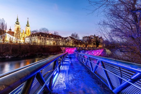 Illuminated Murinsel, Mariahilferkirche in the background, night shot, Graz, Styria, Austria,