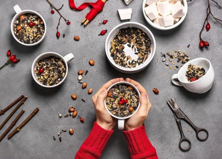 Step 2: All the cups are filled with bird seed and rosehip berries. Making feeding cups.