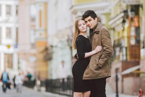 Urban modern young love couple walking romantic talking talking, holding hands on a date. Young