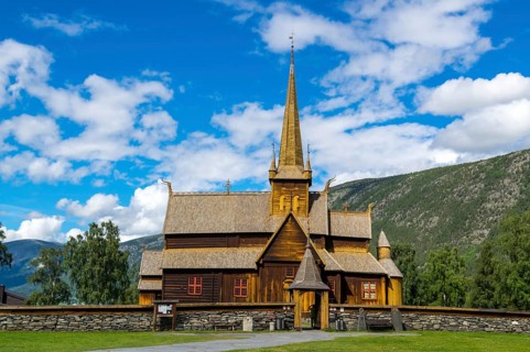The famouse historic wooden church in Lom in Norway with blue sky summertime
