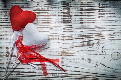 Valentine hearts with ribbons on wooden board holidays concept