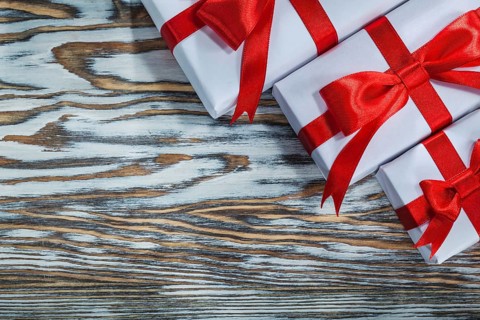 Red packed present boxes on wooden surface