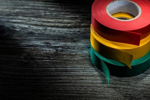 Rolled insulation tapes on wooden board