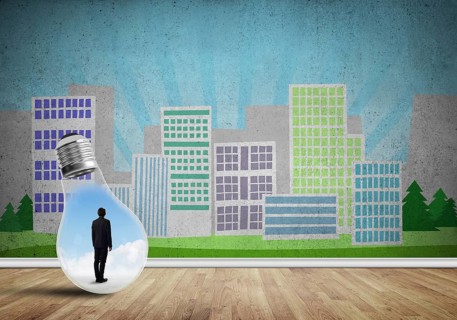 Businessman inside light bulb against city drawn concept