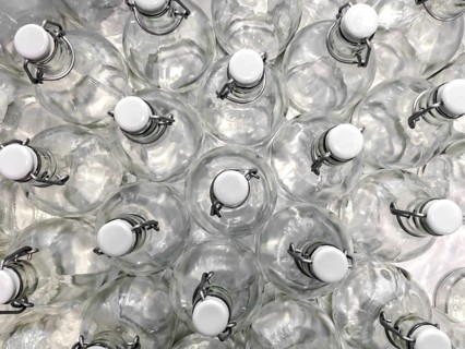 Transparent bottles seen from above. They can be filled with water, wine or other beverage. They