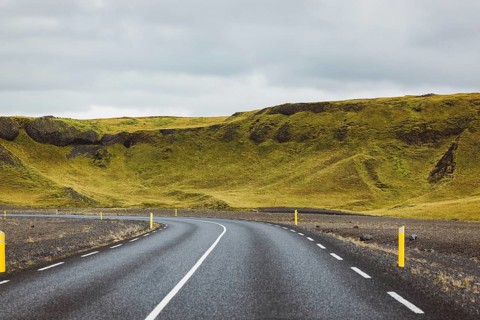 Road and mountain view during road trip in iceland. Foggy landscape in autumn time.