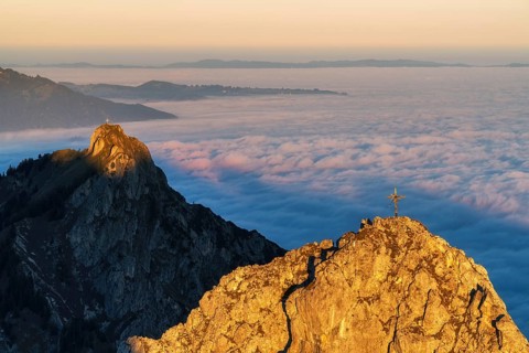 Peaks im Ammergauer Alpen alps at sunrise, above the clouds in the valley