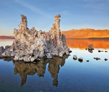 The magic of Mono Lake. Outliers - bizarre limestone formations reflected in the smooth water.