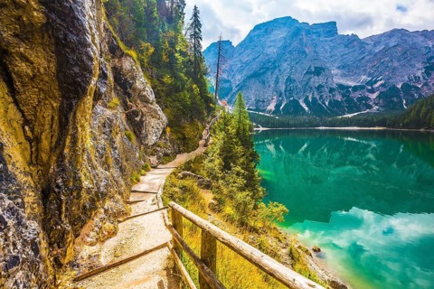 The concept of environmental and hiking. Walking trail around the lake is fenced with wooden