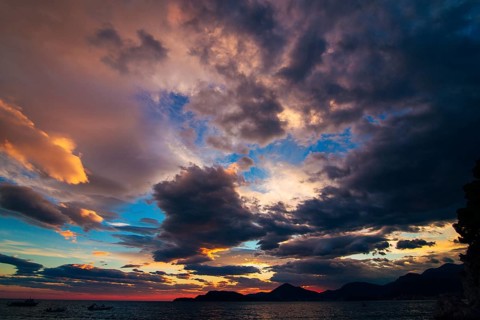 Sunset in Montenegro over the mountains and the sea. Orange sunsets