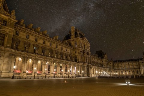 Scenic starry night sky above the Parisian Louvre Palace, France, Europe