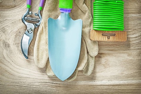 Working gloves secateurs hand spade garden soft tie on wooden board gardening concept