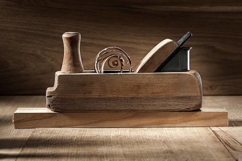 Carpenter tools woodworkers plane on vintage wooden background