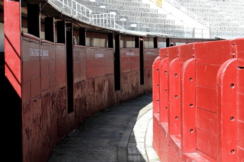 Madrid, Spain, Europe, Narrow entrances in the arena with red walls and names of the areas, Las