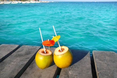 Coconut coktails in caribbean on wood pier turquoise sea
