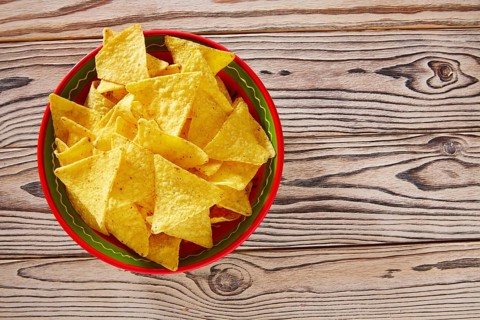 Nachos mexican food tortilla on red white wood background